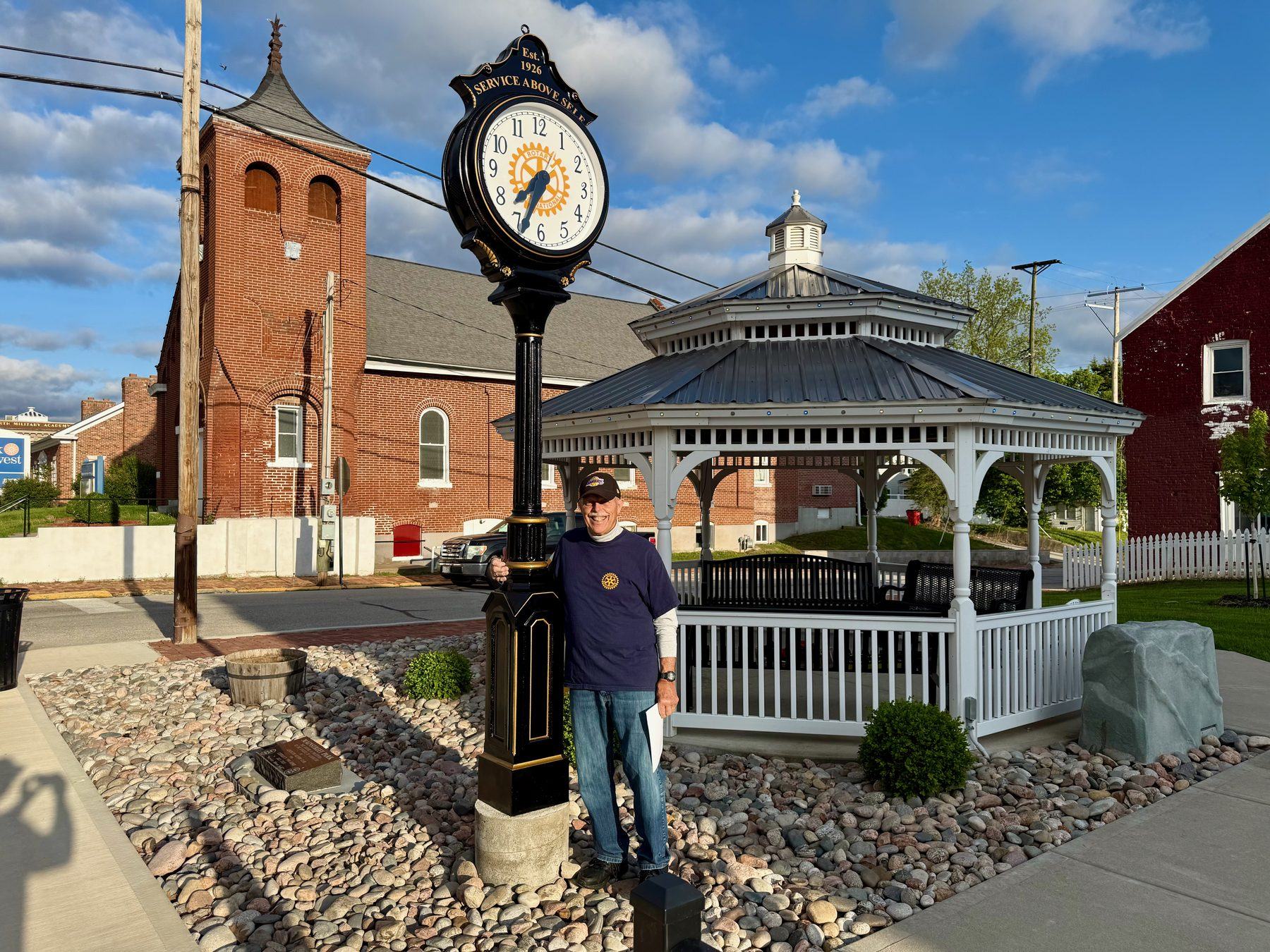 A Lexington Rotarian at the club’s Service Above Self street clock and gazebo