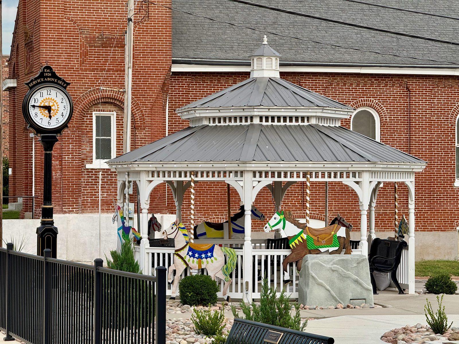 Mainstreet Park gazebo with painted carousel horses and the Rotary clock